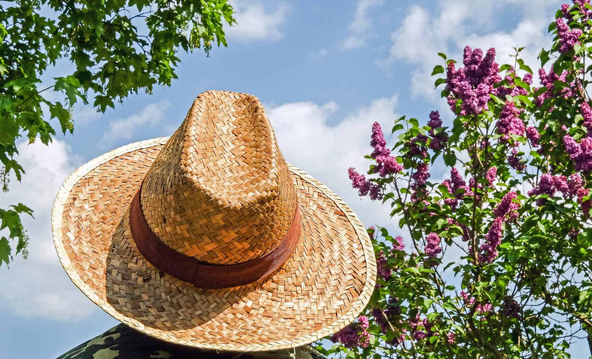 person in a straw hat standing outdoors