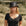 Woman wearing a black top hat and black dress in a desert setting