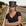 Woman wearing a black leather top hat on train tracks