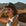 Woman wearing a hat in a desert setting with mountains in the background