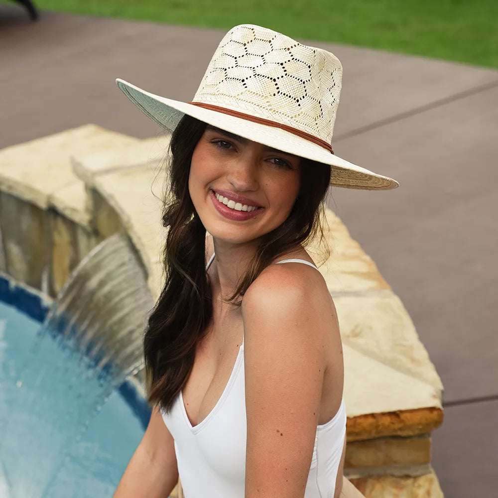 Woman wearing a straw hat by a poolside