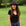 Woman wearing a black hat and black top in a park