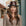 Woman wearing a brown leather hat in an urban setting