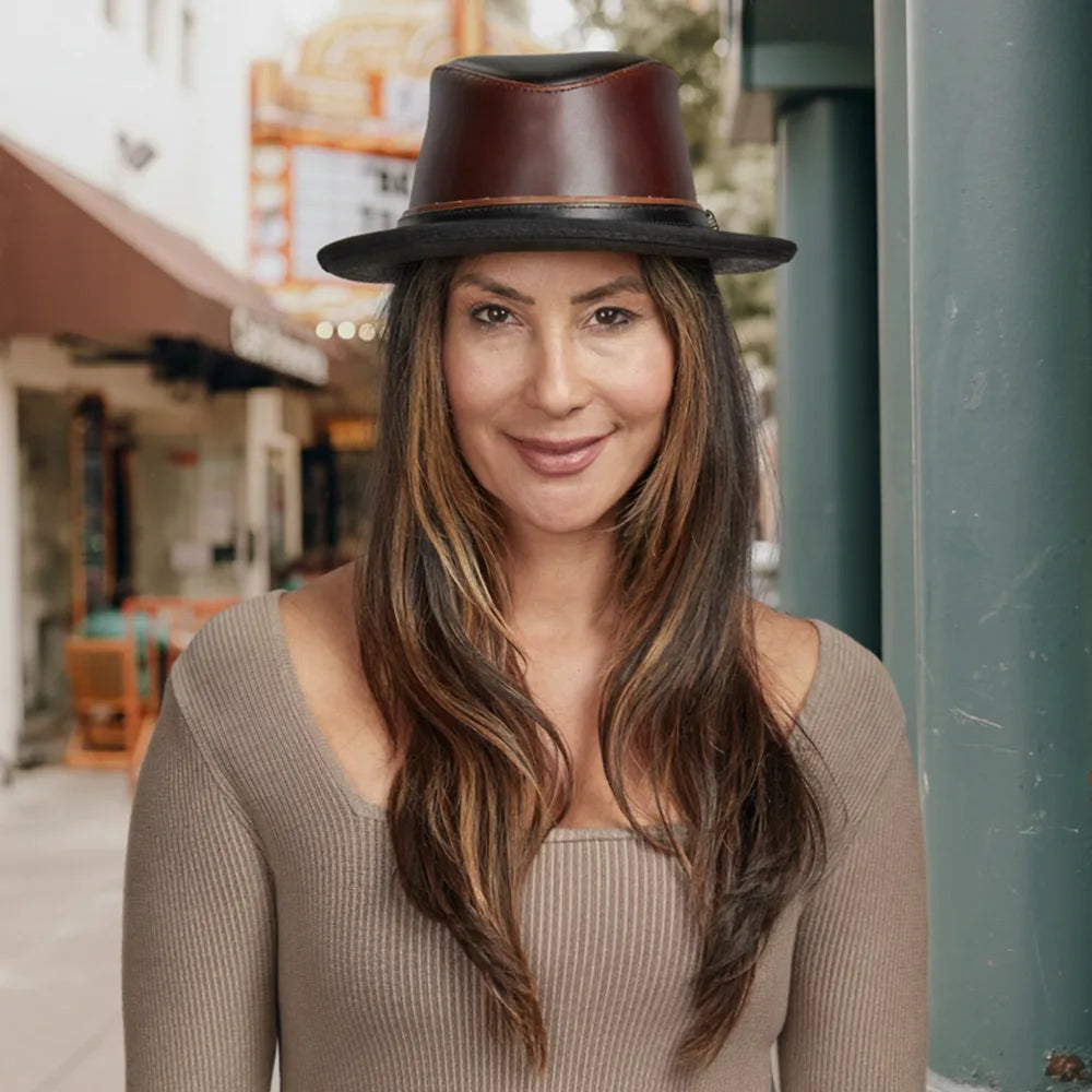 Woman wearing a brown leather hat in an urban setting