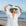 Woman wearing a light blue hat and white dress on a beach