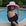 Woman wearing a pink hat by a pool