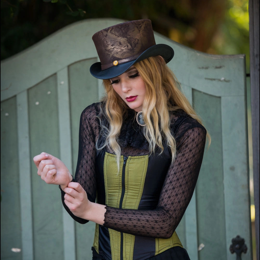 Woman wearing a top hat and black lace outfit against a wooden background