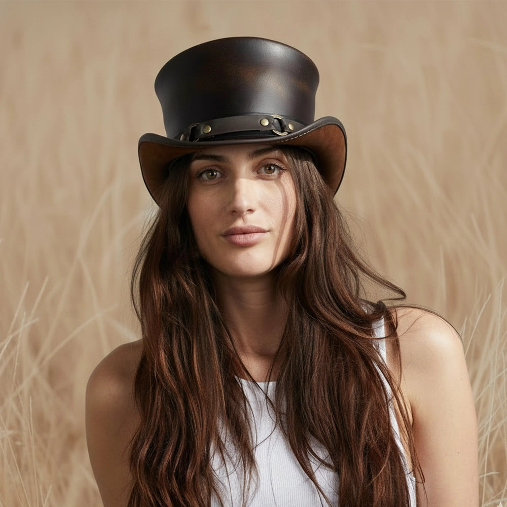 Woman wearing a black leather top hat against a neutral background
