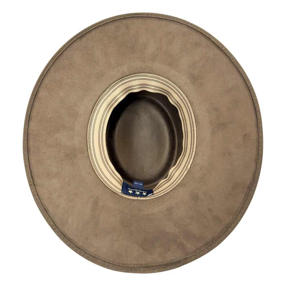 A top-down view of a wide-brimmed cowboy hat in a taupe brown suede-like finish, featuring a cream striped inner band and a small blue brand tag.