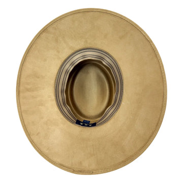 A top-down view of a wide-brimmed cowboy hat in a light tan suede-like material, showing the striped inner band and a small blue brand tag.