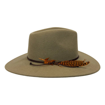A wide-brimmed felt hat in a muted olive-tan color, featuring a dark band and a decorative brown and orange feather accent on the brim, set against a plain white background.