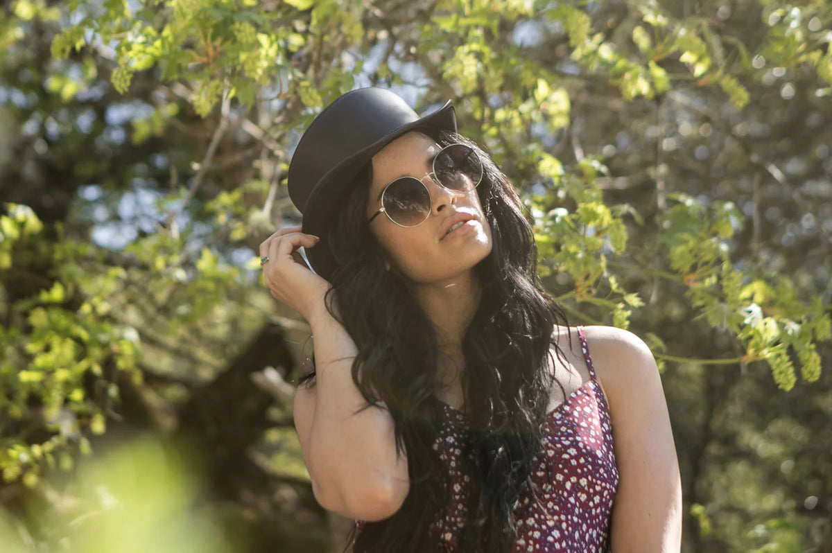 Woman in forest wearing the Bromley womens pork pie hat by American Hat Makers