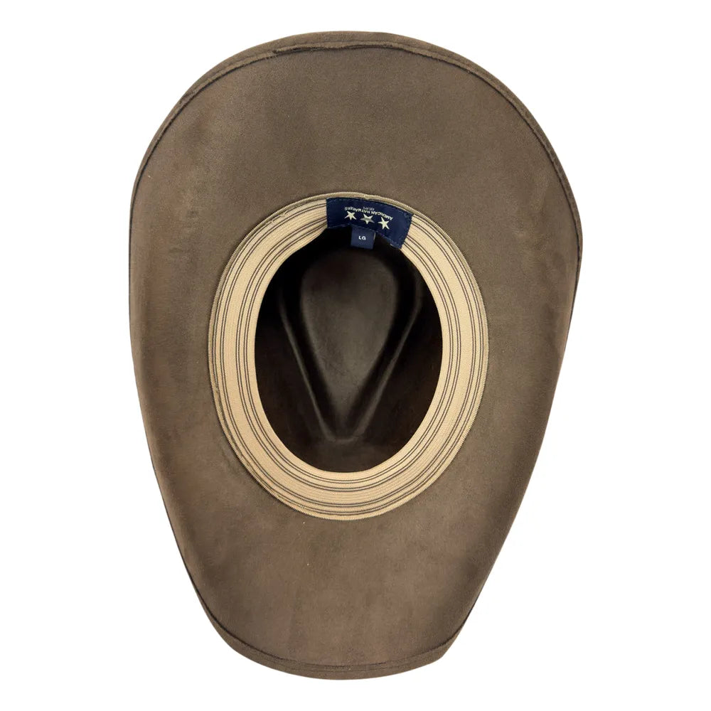 A brown cowboy hat viewed from the inside, showing a wide beige striped brim opening and a small blue interior label.