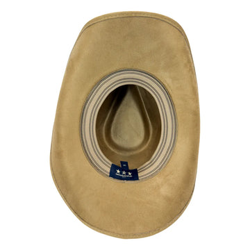 A tan suede cowboy hat viewed from directly above, showing the interior crown and a blue brand tag near the base.