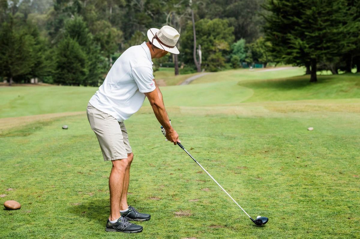 Man golfing while wearing the Milan mens hat by American Hat Makers