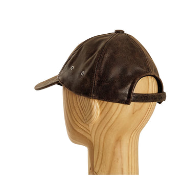 Brown leather cap on a wooden mannequin head against a white background