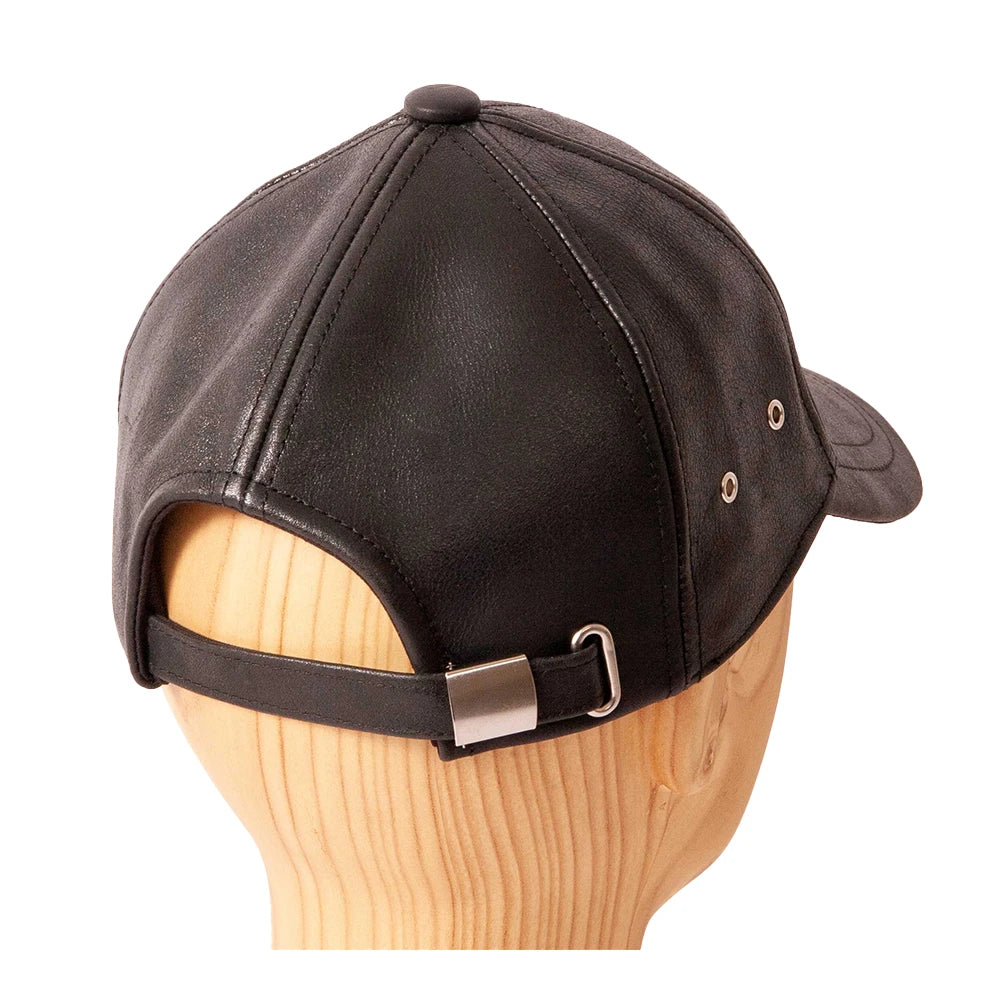 Black cap on a wooden mannequin head with a white background